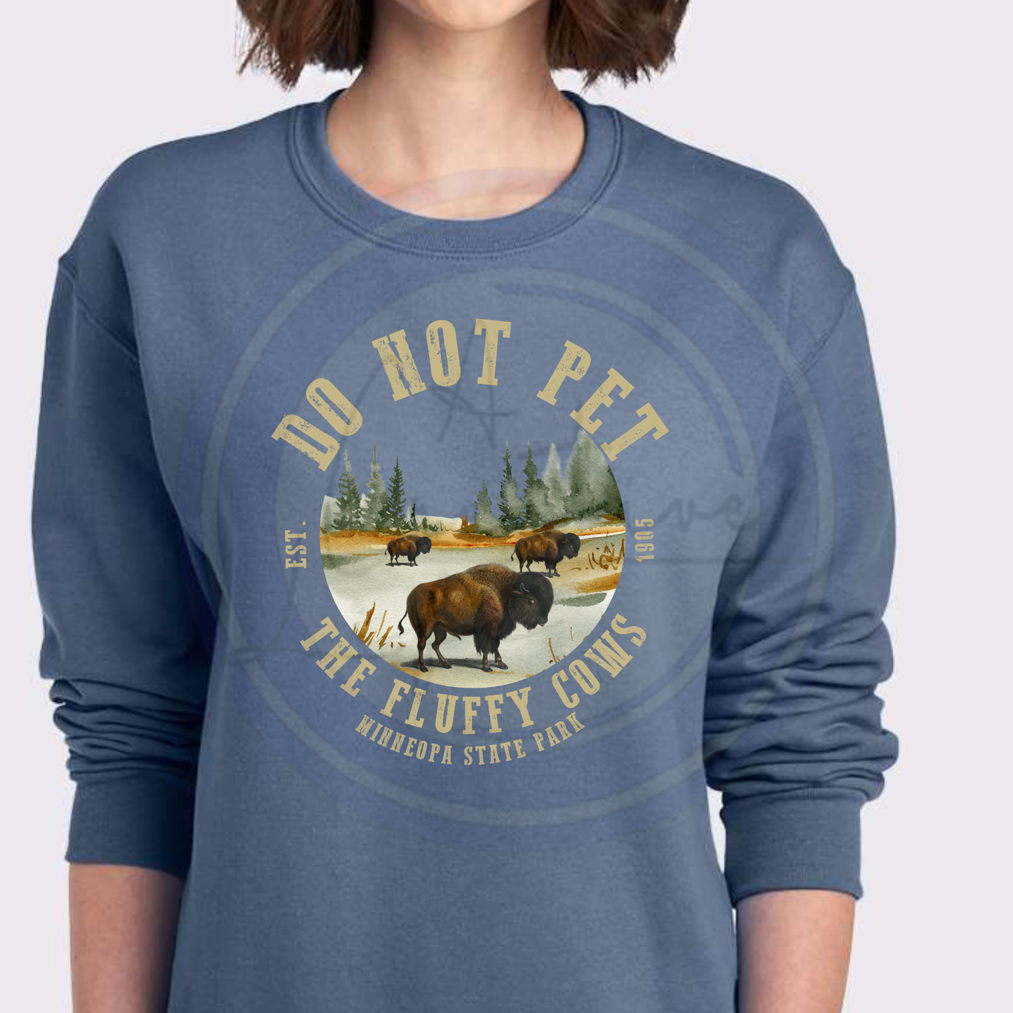 Blue sweatshirt with bison graphic and text 'Do Not Pet the Fluffy Cows' on a white background